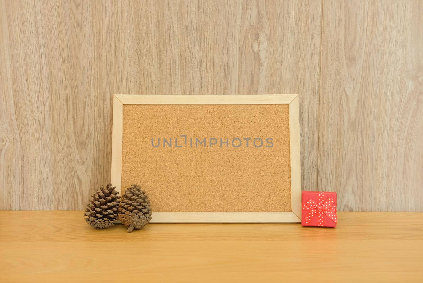 blank cork board with pine cone & gift box. christmas new year holiday festival.
