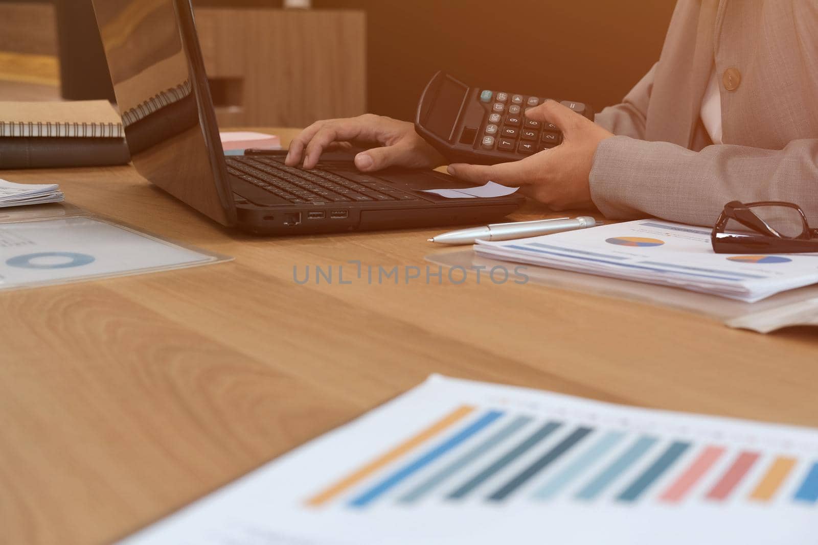 financial adviser working with calculator & computer. accountant doing accounting & calculating revenue & budget. finance & economy concept by pp99