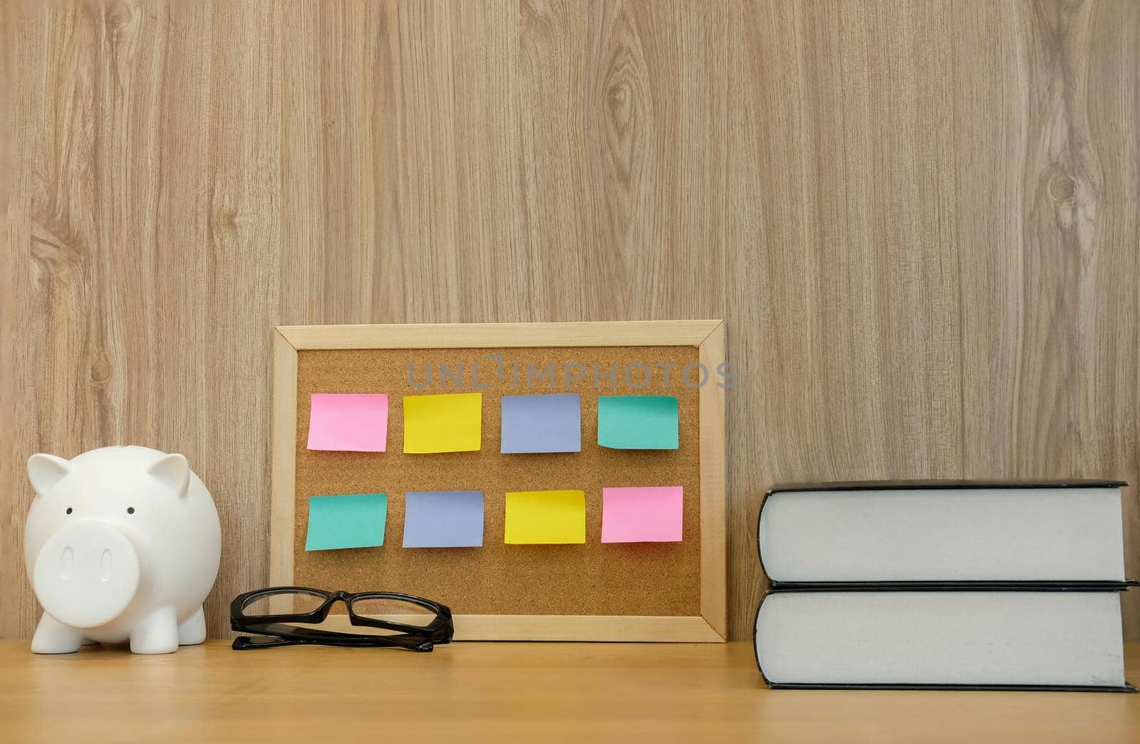 sticky notes on cork board & piggy bank. money saving finance investment concept by pp99