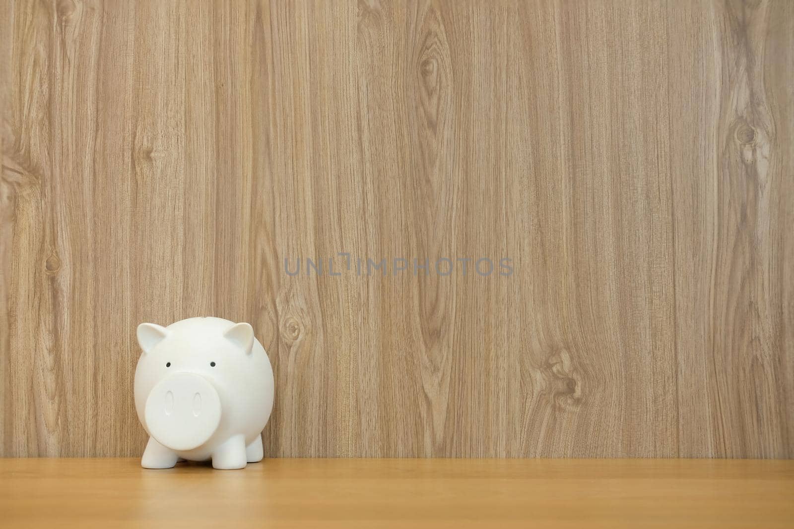 piggy bank on wooden desk. money saving finance investment concept
