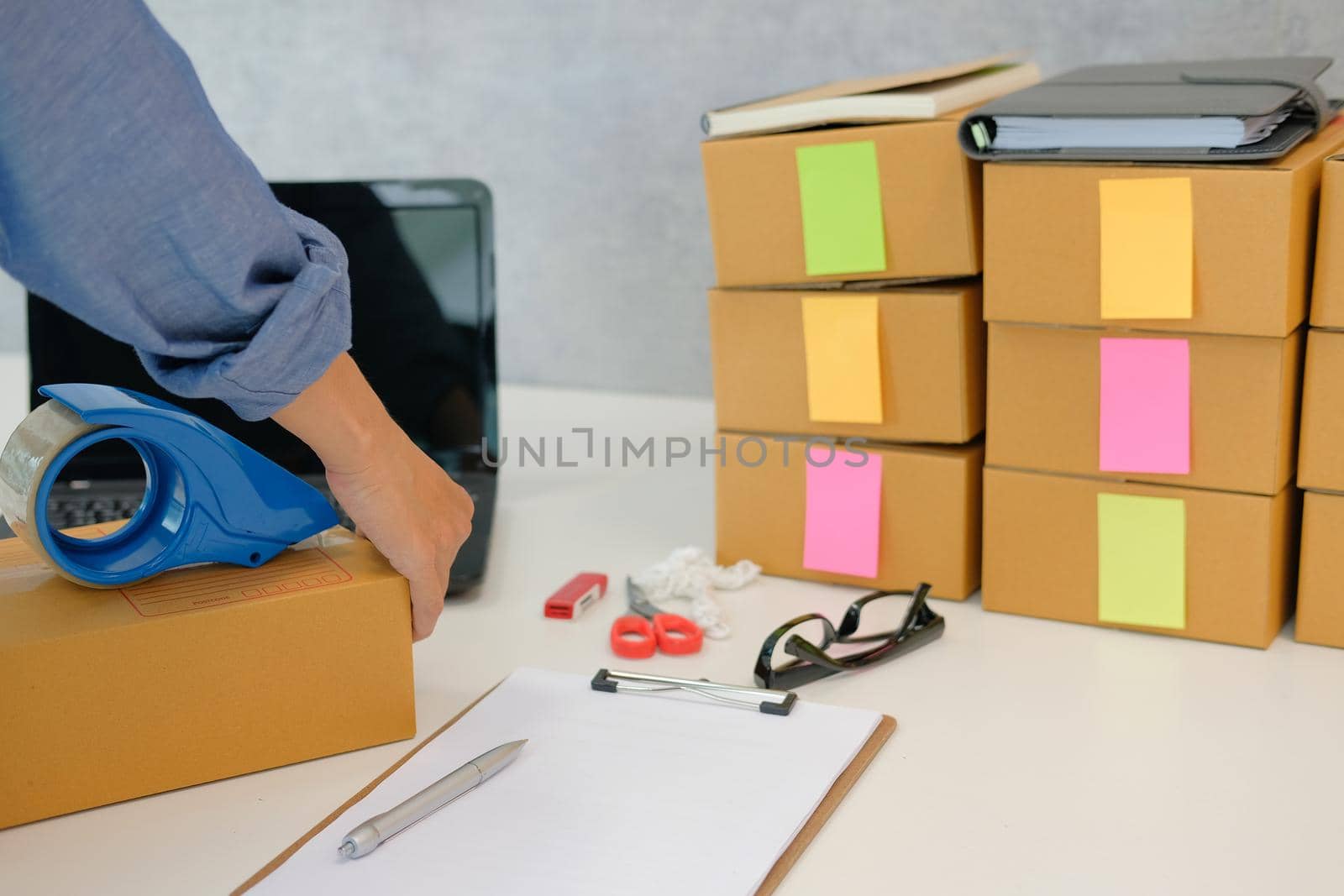 startup small business owner packing cardboard box at workplace. freelance woman entrepreneur seller prepare parcel box of product for deliver to customer.  Online selling, e-commerce concept