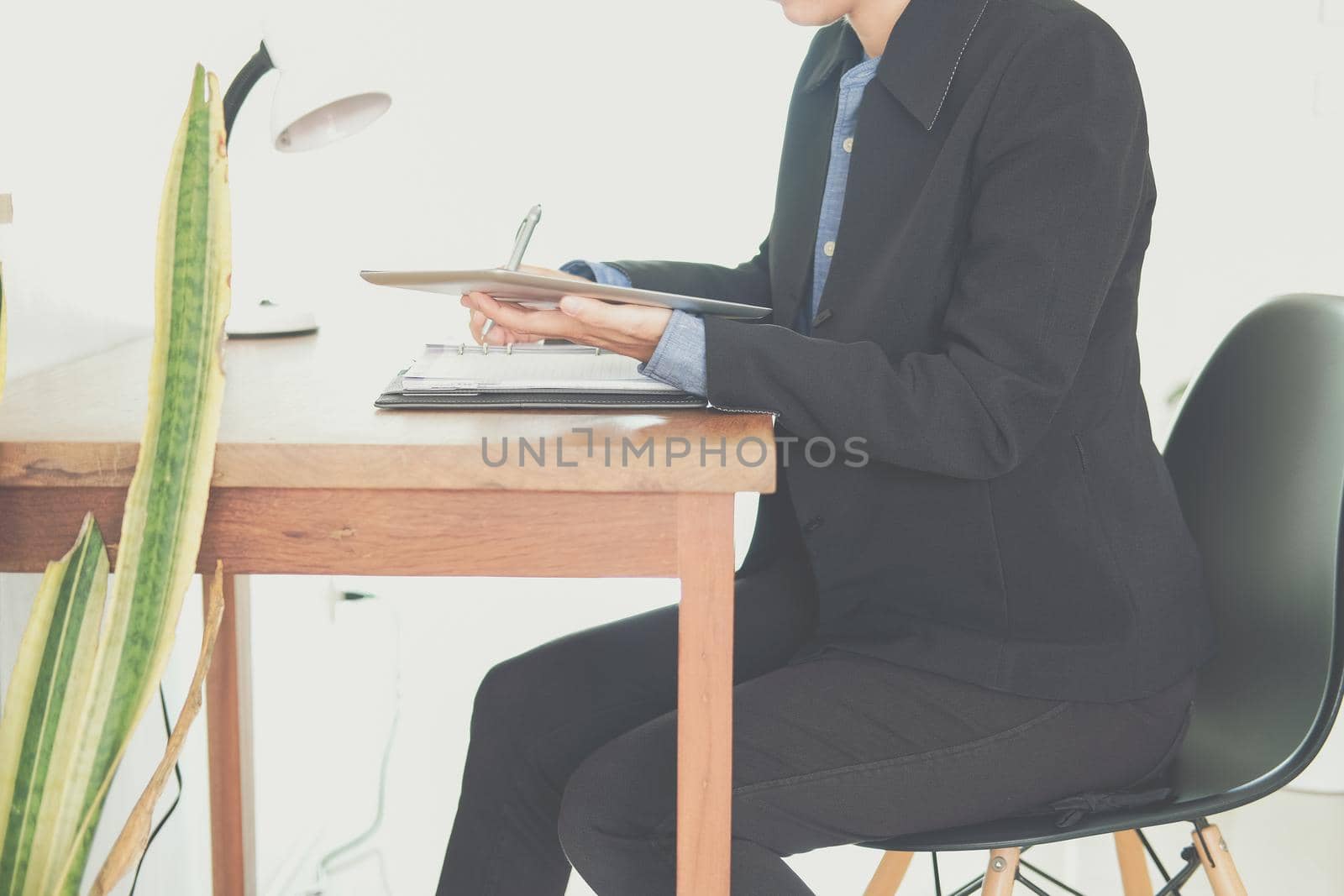 woman organizing plan with notebook & tablet. businesswoman working  at workplace coworking office