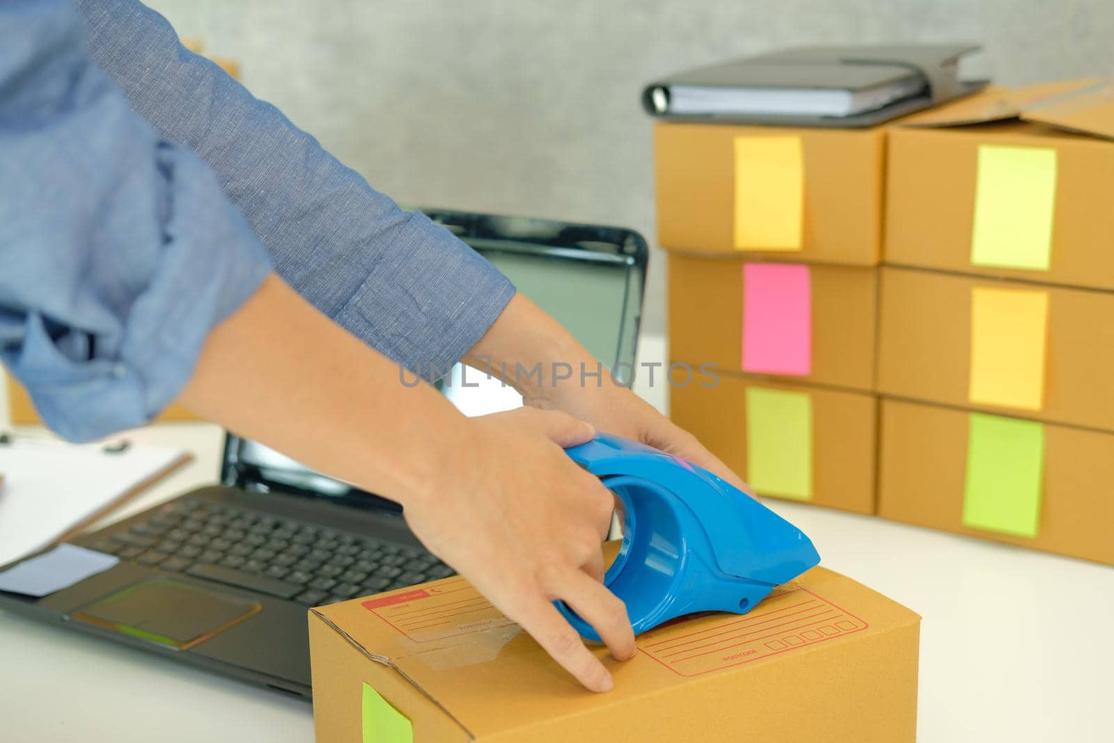 startup business owner packing cardboard box. woman seller prepare parcel box.  Online selling, e-commerce concept by pp99