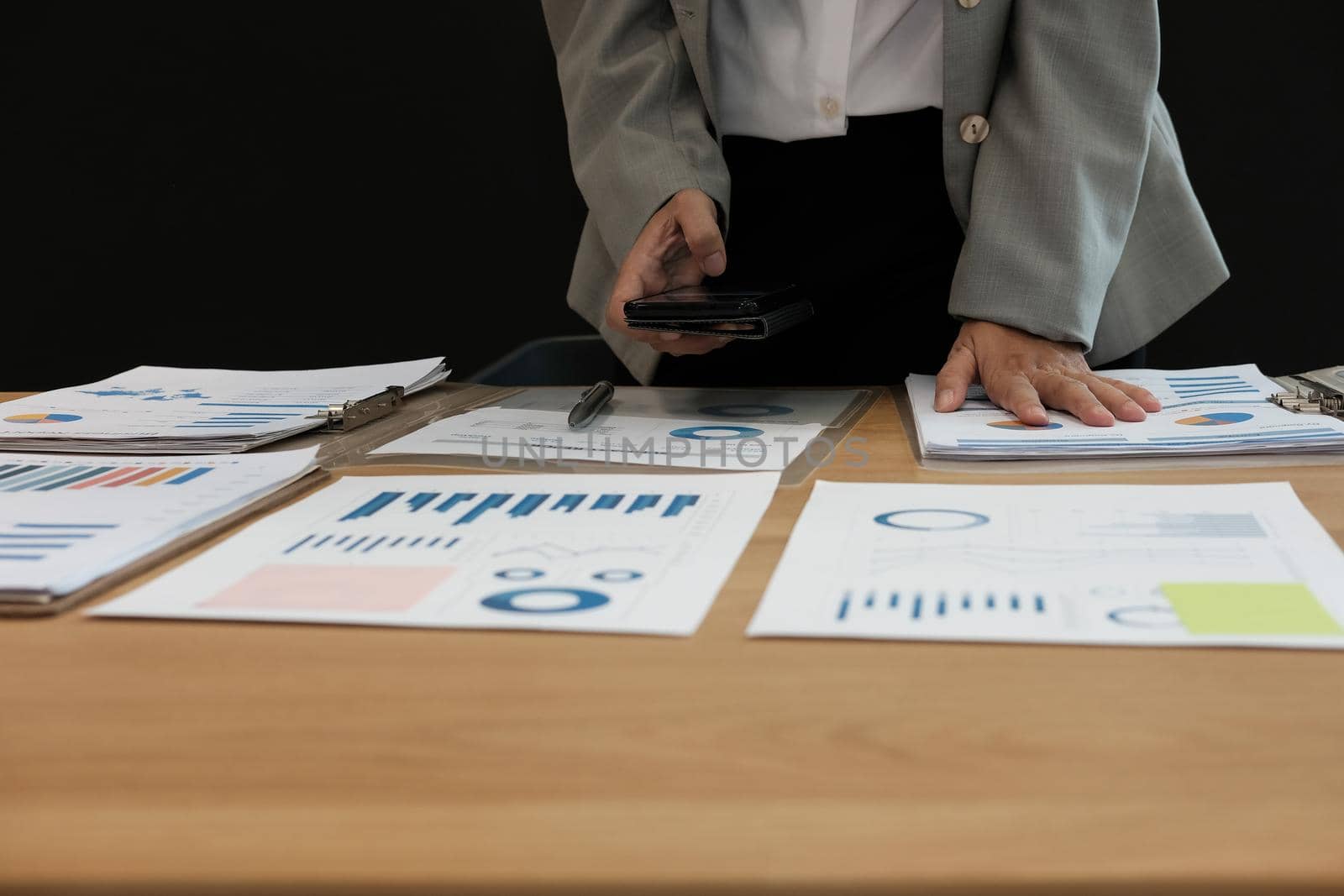 man working organizing plan with smart phone. businessman analyzing document at workplace coworking office