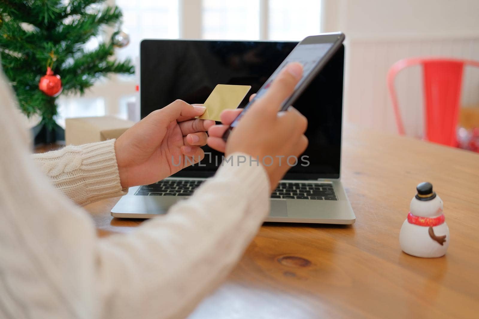 man holding credit card & smart phone for online shopping.  male buyer buying christmas gift on internet. merry xmas new year holiday celebration