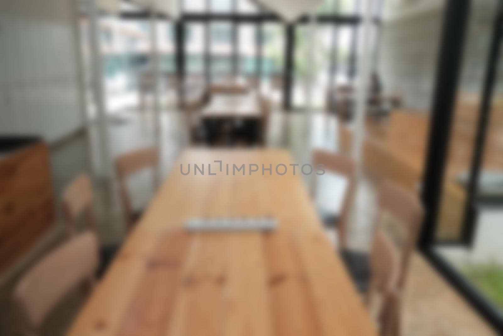 cafe coffee shop cafeteria blur defocused background with wood table for display montage product