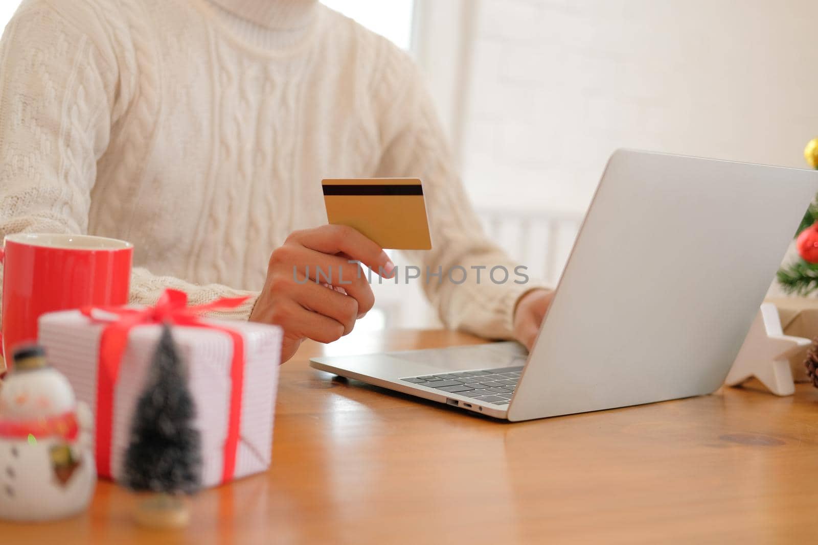 man holding credit card for online shopping. male buyer buying christmas gift on internet. new year holiday merry xmas celebration