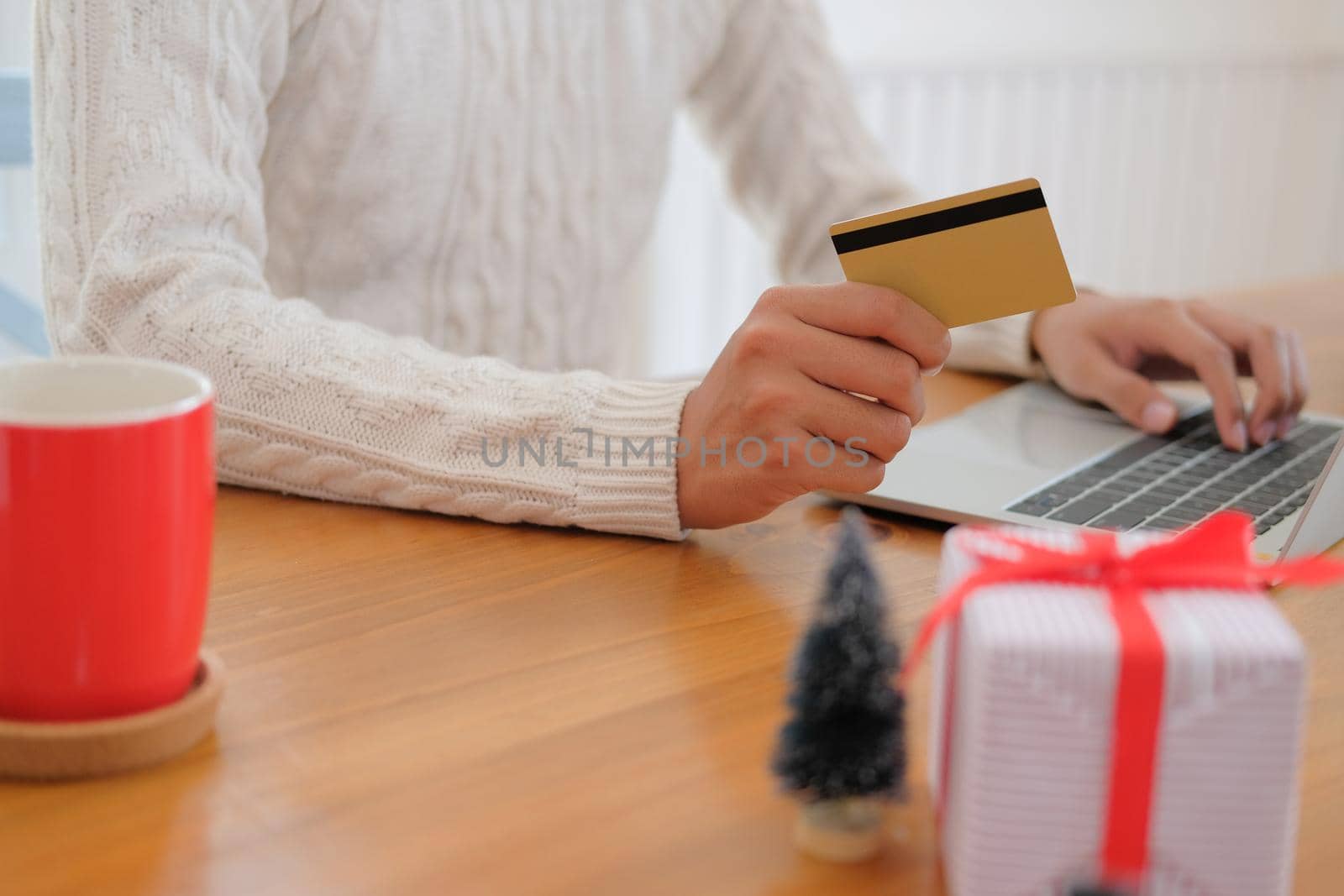 man holding credit card for online shopping. male buyer buying christmas gift on internet. new year holiday merry xmas celebration