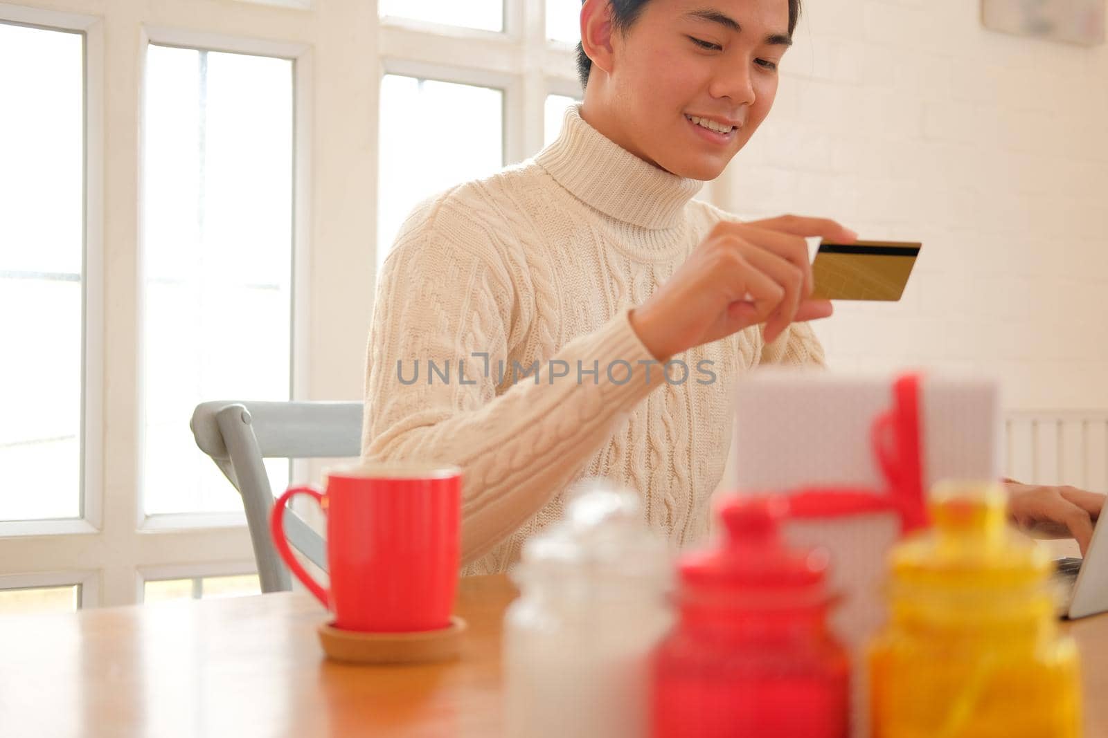 man holding credit card for online shopping. male buyer buying christmas gift on internet. new year holiday celebration by pp99