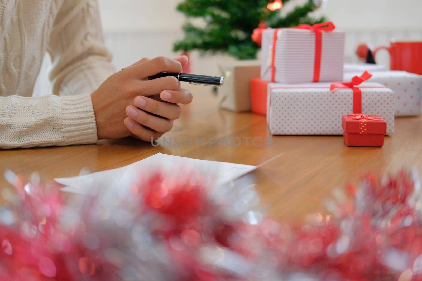 man wearing cream sweater thinking with pensive expression. christmas decoration at xmas new year holiday celebration.