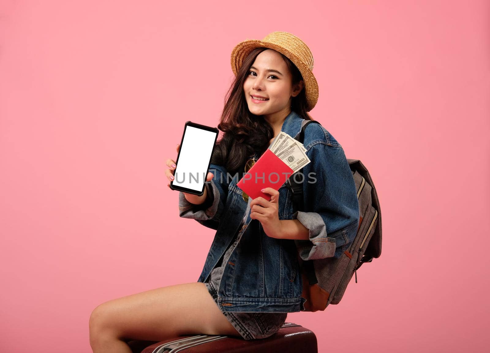 young asian woman backpacker traveler with passport money backpack. journey trip travel. studio shot