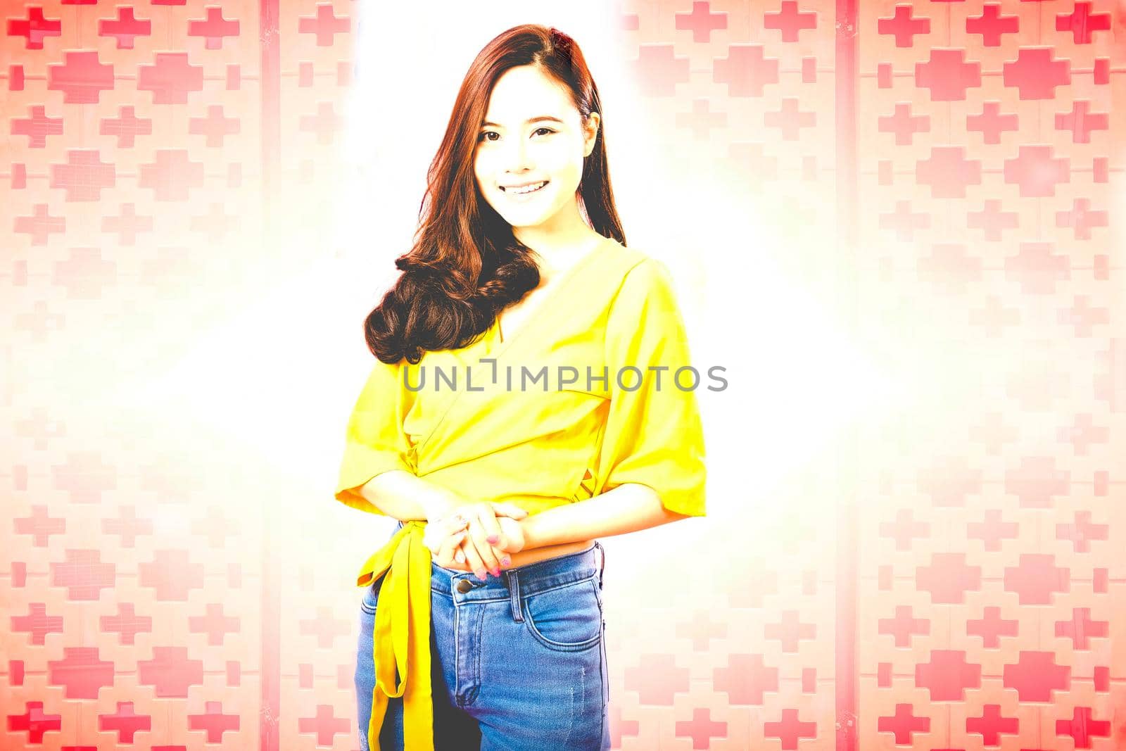 portrait of smiling young asian woman in casual clothing. studio shot