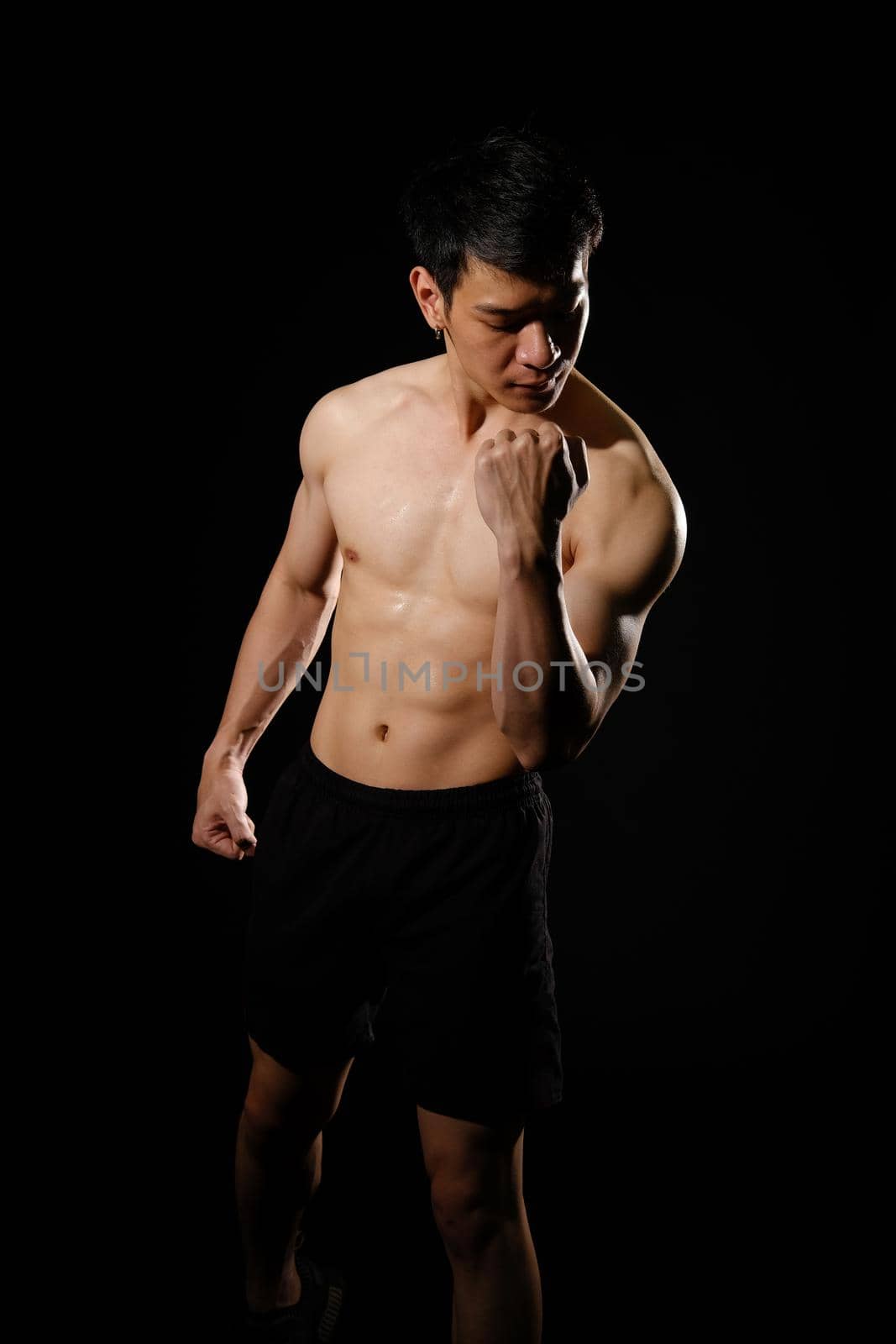 portrait of athletic muscular bodybuilder man with naked torso six pack abs. fitness workout concept