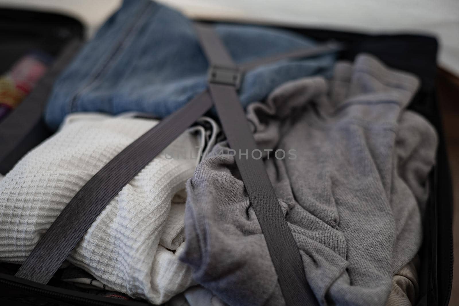 Clothes that are packed in luggage by iPixel_Studio
