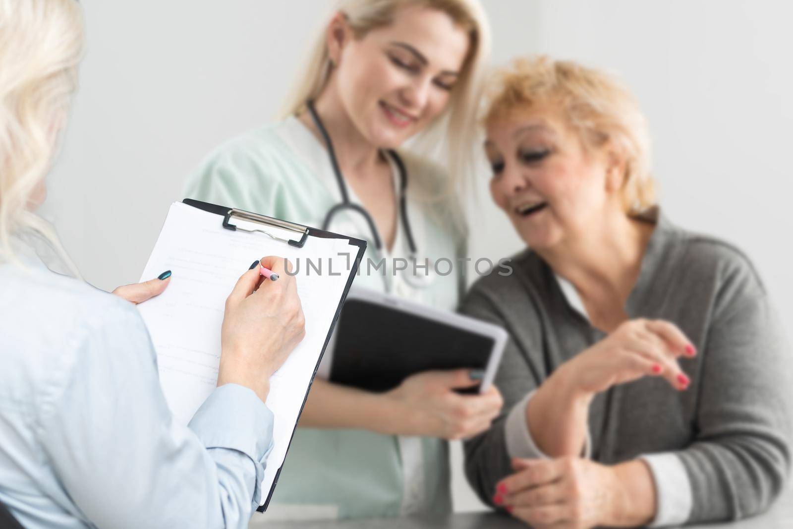 female doctor consulting mature patient about treatment at meeting in hospital office, therapist and senior woman discussing checkup results, healthcare by Andelov13