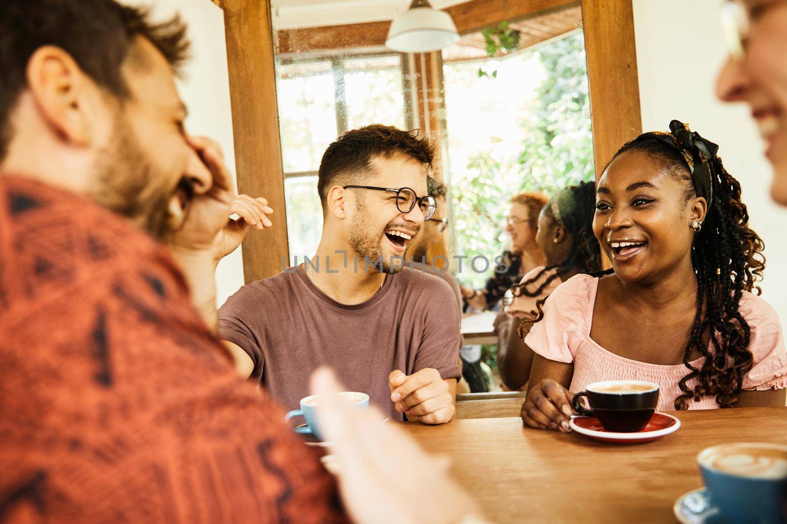 Group of young happy people friend having fun in a coffee shop