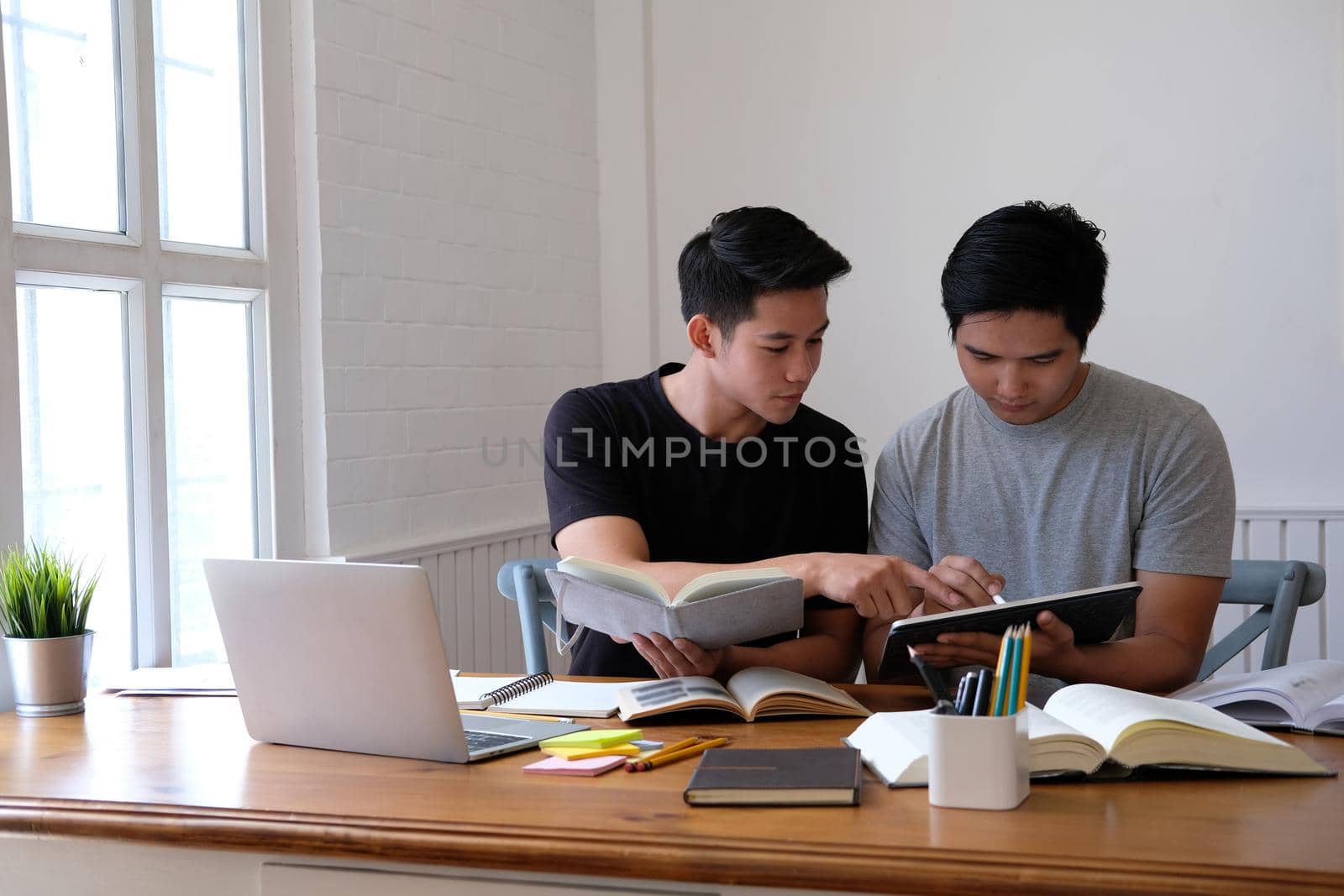 designer working on graphic tablet discussing creative idea of startup project with partner