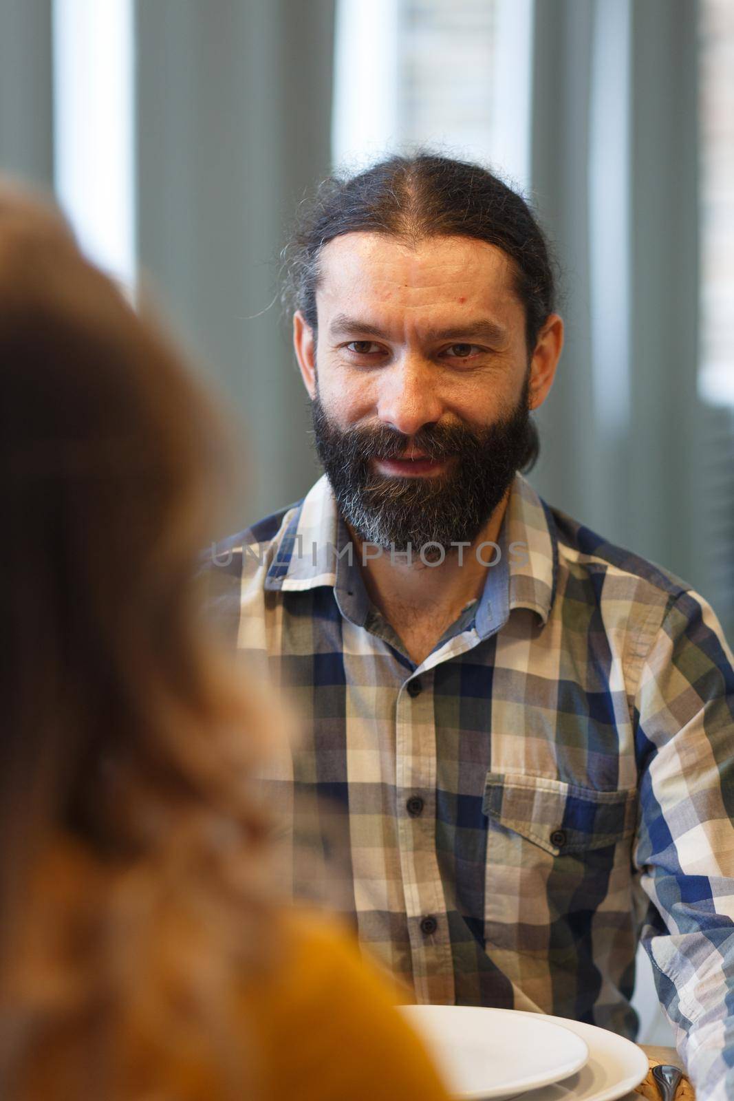 A handsome man with a beard sits and admires his wife by BY-_-BY