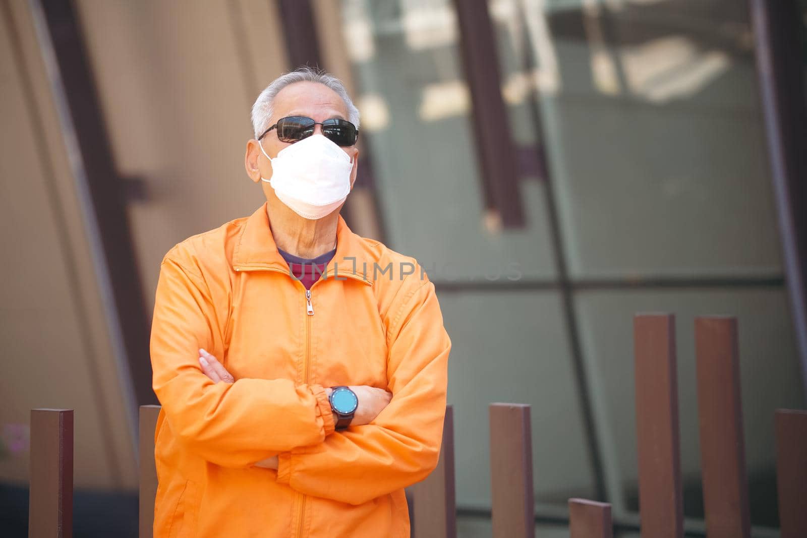 old elderly senior elder man wearing facial mask relaxing on terrace. mature retirement lifestyle