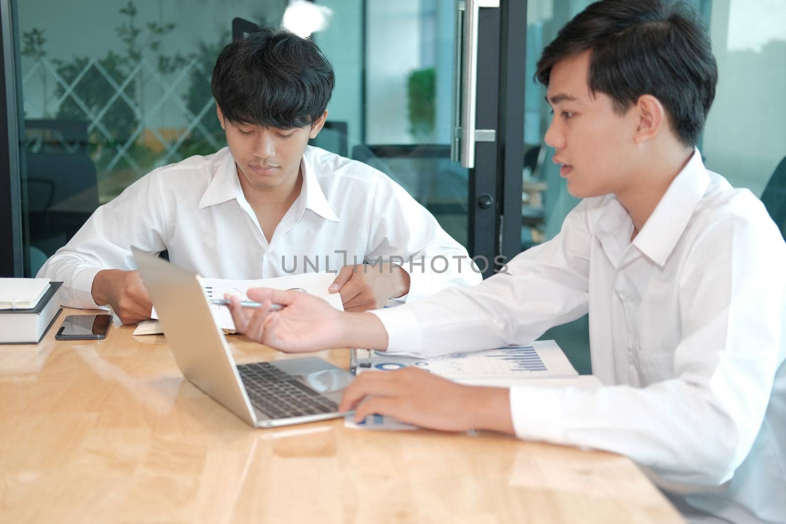 financial adviser analyzing performance revenue with investor. business people discussing in meeting. businessman working with co-worker team.