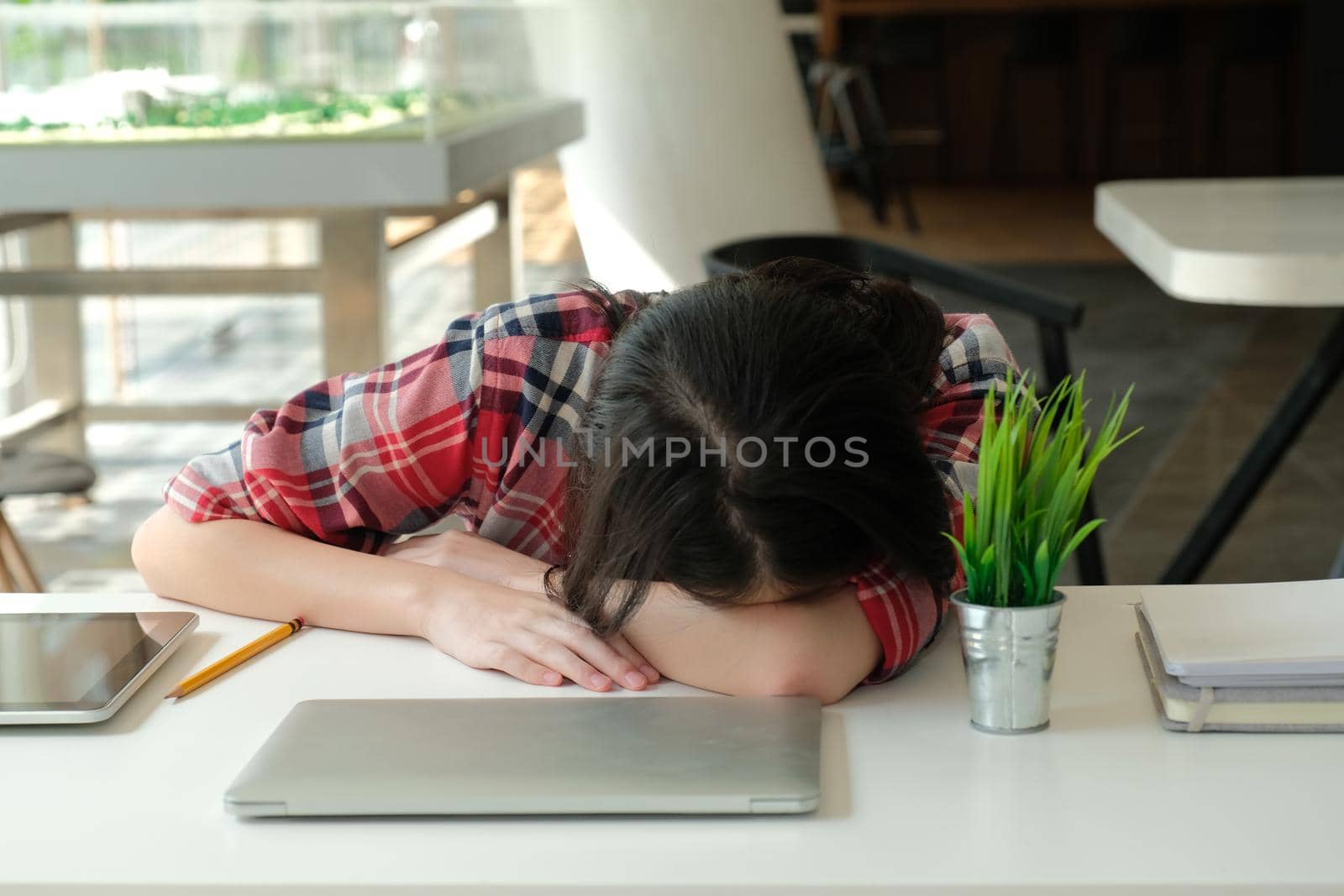 woman sleeping at workplace. girl tired exhausted from hard work