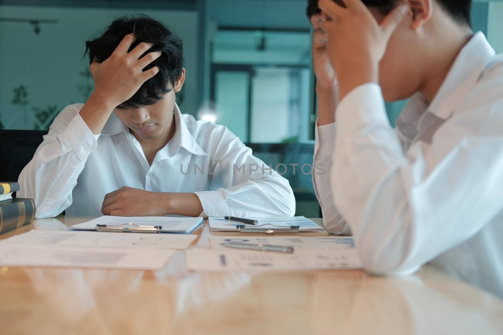 man feeling tired, frustrated stressed from hard work. exhausted businessman have headache at workplace.