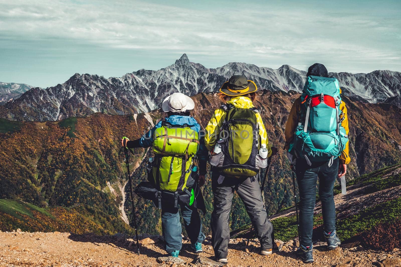 Epic adventure of hiker do trekking activity in mountain of Northern Japan Alps, Nagano, Japan, with panoramic nature mountain range landscape. Motivation leisure sport and discovery travel concept.