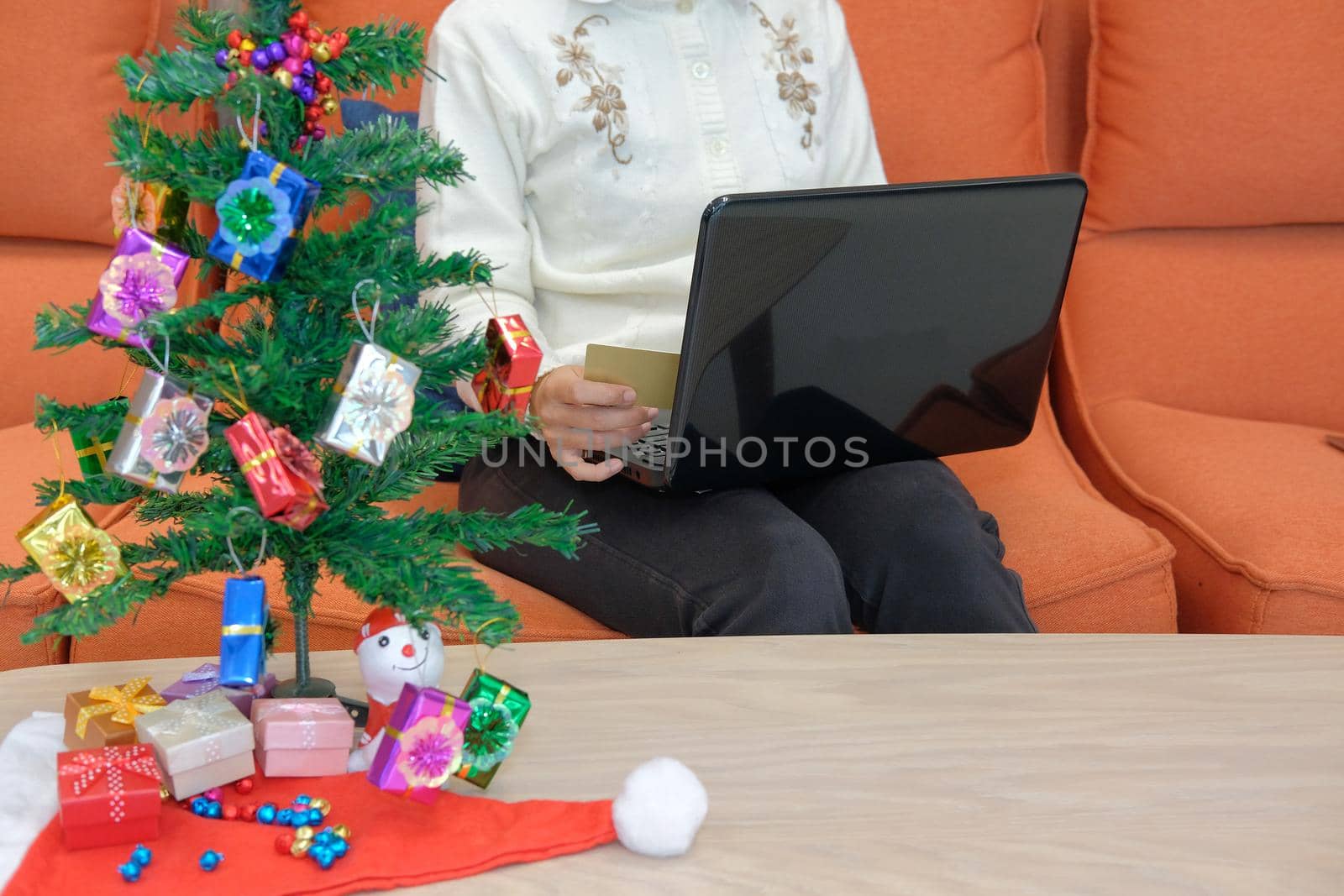 woman holding credit card for online shopping.  female buyer buying christmas gift on internet. new year holiday merry xmas celebration