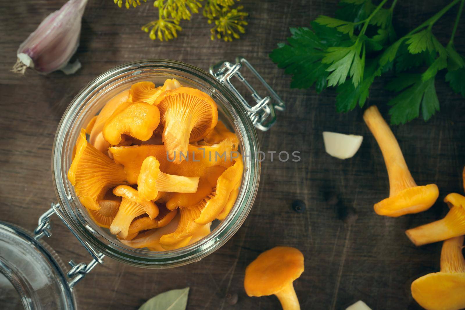 Preserving chanterelle mushrooms in a jar with spices and herbs. Pickling wild edible mushrooms. Flatlay, topview. by galsand