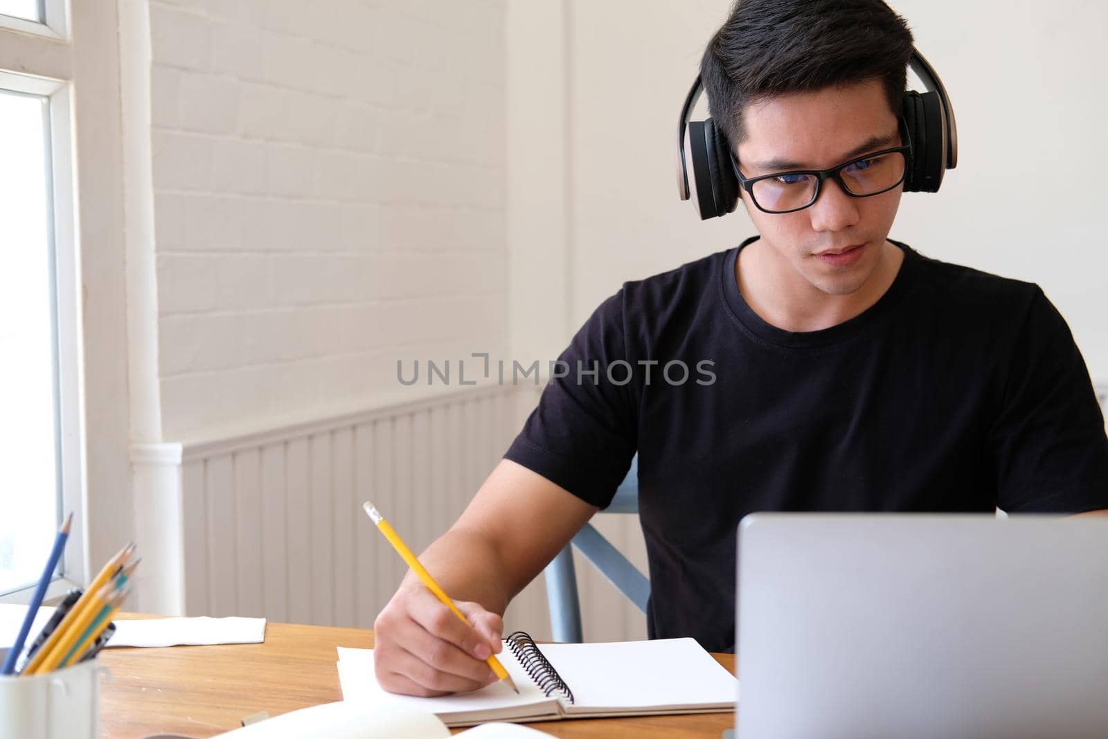 man college student  studying learning lesson with computer online & taking note