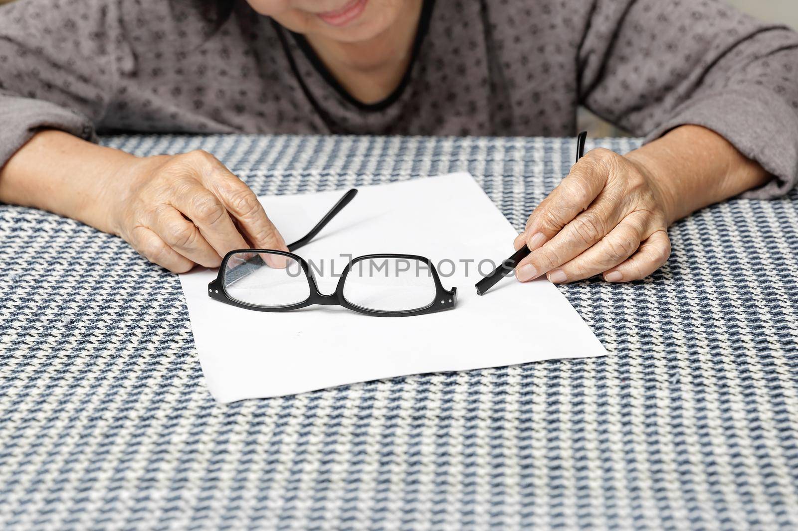 Elderly asian woman repair broken glasses by toa55