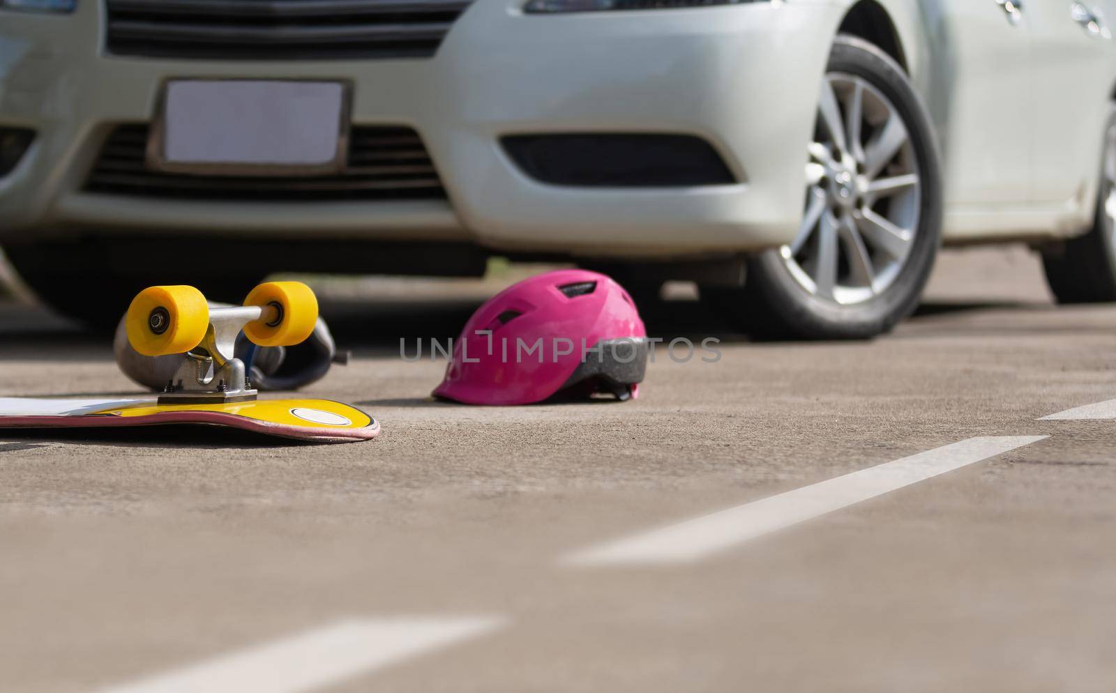 Accident skateboard crashes car after stunt on street and lost control.