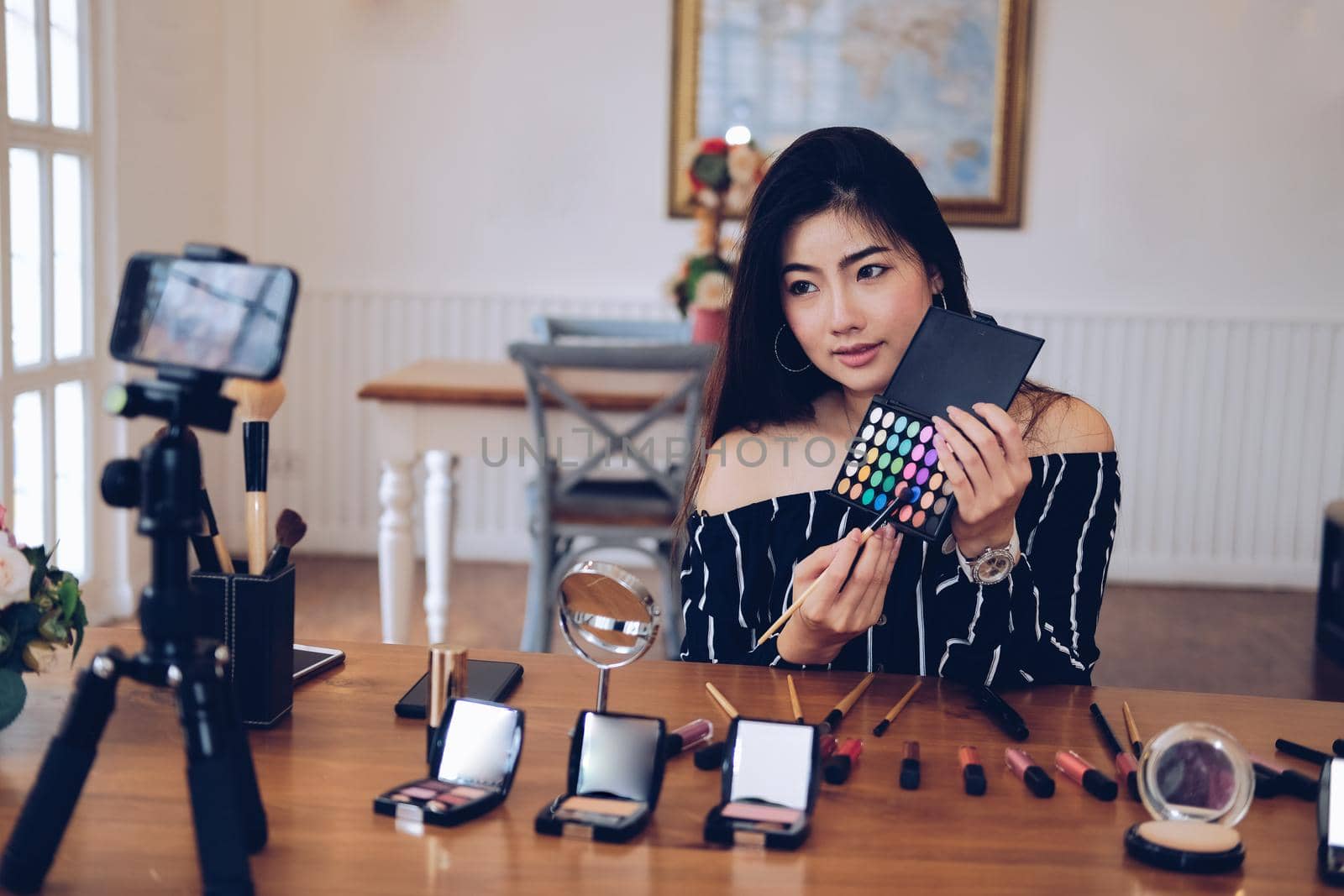 beauty blogger live broadcasting cosmetic makeup tutorial on social media. vlogger recording vlog video. influencer marketing