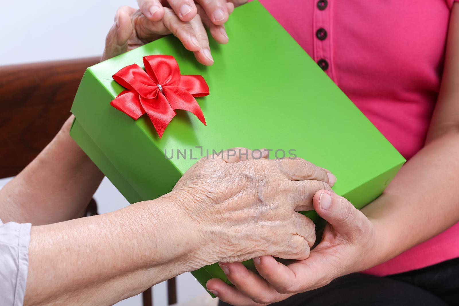 Elderly woman receiving a gift from daughter by toa55