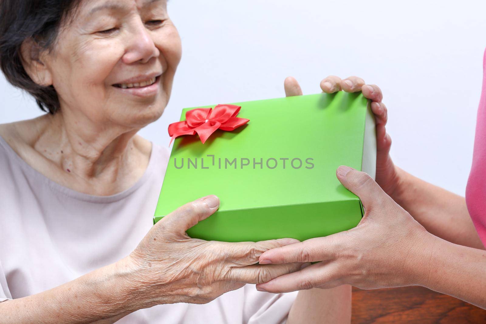 Elderly woman receiving a gift from daughter by toa55