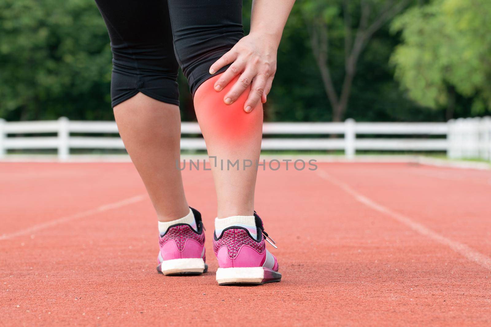 Middle aged woman runner muscle pain during training outdoors by toa55