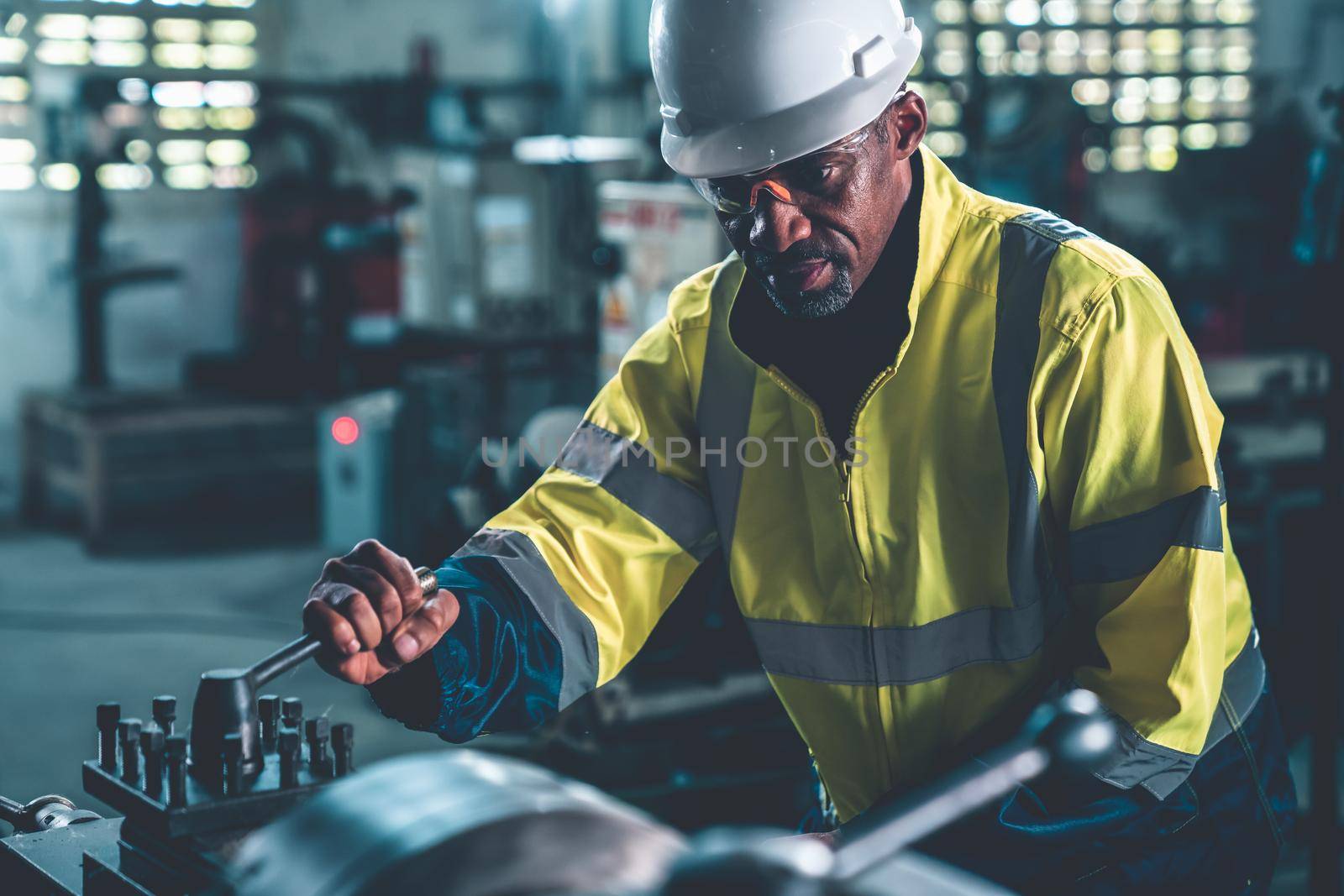 Factory worker or engineer do machine job in adept manufacturing workshop . Industrial people and manufacturing labor concept .