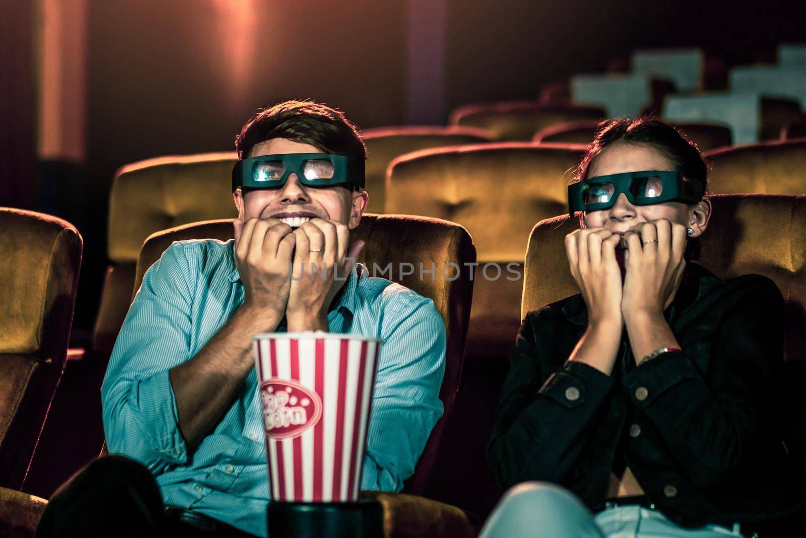 Man and woman in the cinema watching a 3D movie by biancoblue