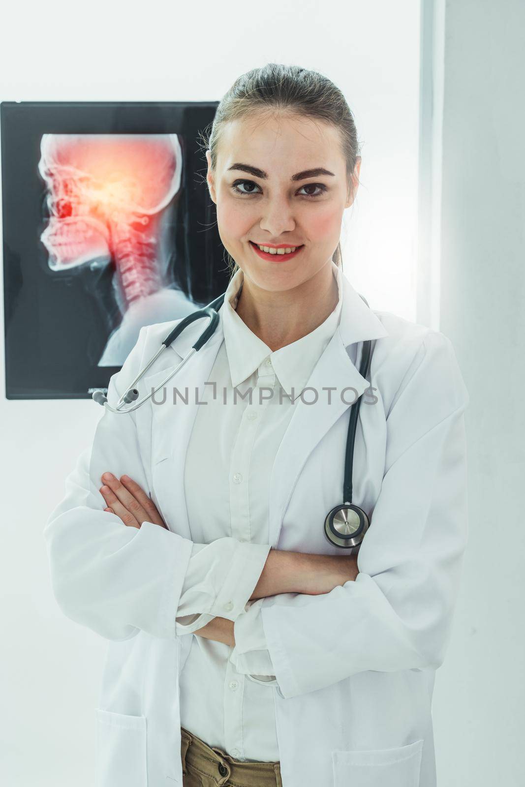 Female doctor working with x ray film of patient head and diagnose skull injury. Medical and healthcare staff service concept.