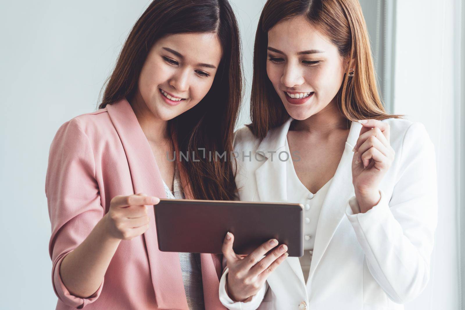 Businesswoman executive is in meeting discussion with another businesswoman or client in modern workplace office. People corporate business team concept.