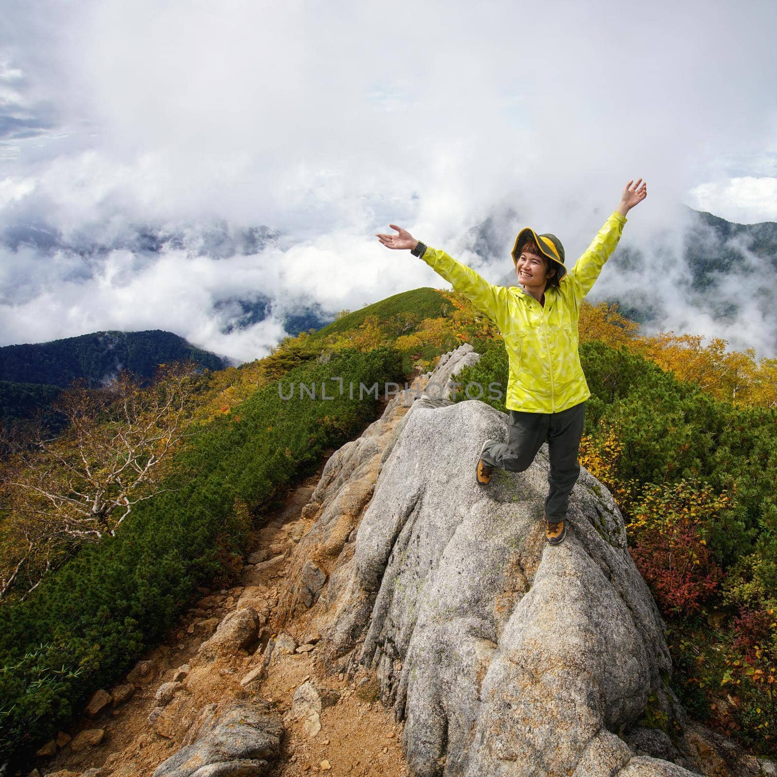 Epic adventure of hiker do trekking activity in mountain of Northern Japan Alps, Nagano, Japan, with panoramic nature mountain range landscape. Motivation leisure sport and discovery travel concept.