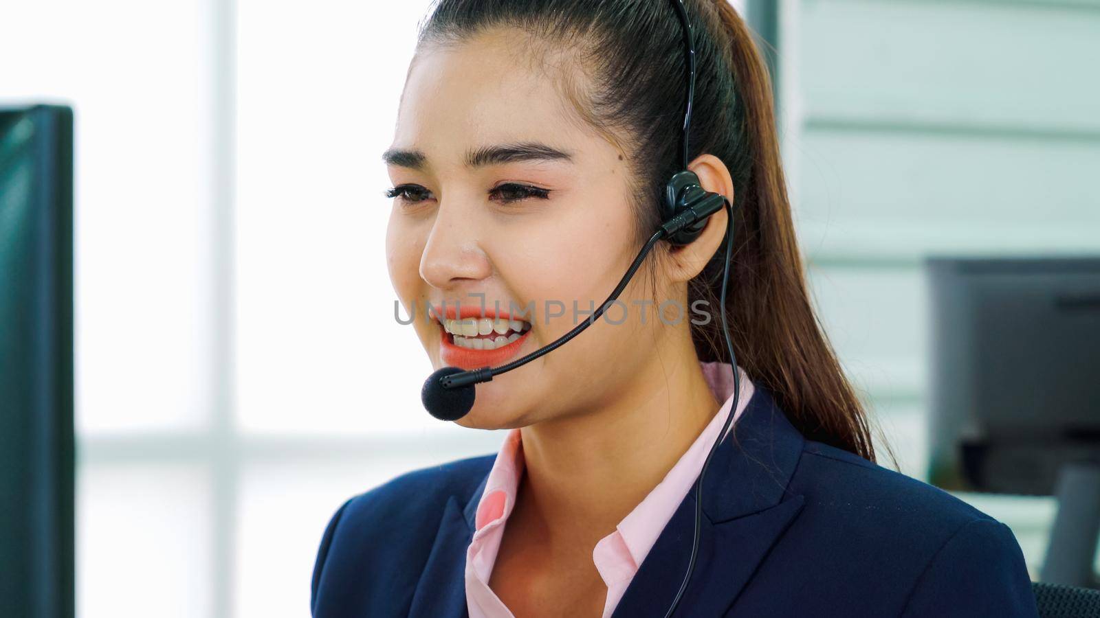 Business people wearing headset working in office to support remote customer or colleague. Call center, telemarketing, customer support agent provide service on telephone video conference call.