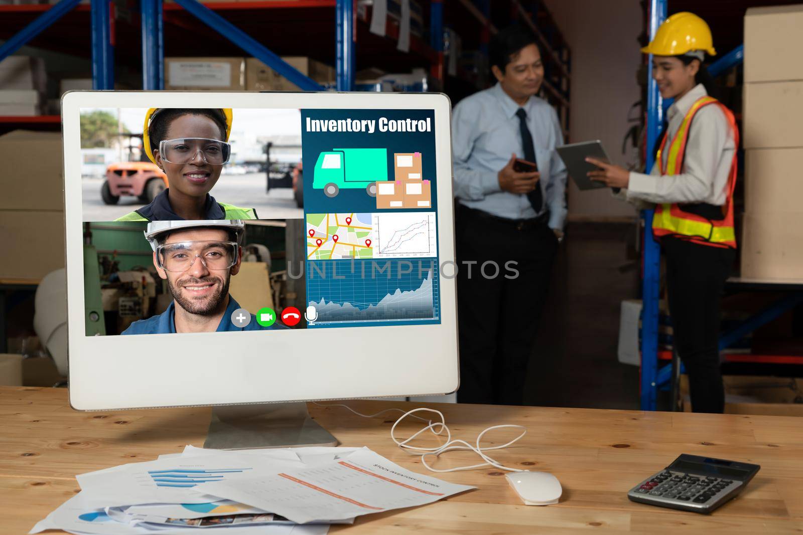 Warehouse staff talking on video call at computer screen in storage warehouse . Online software technology connects people working in logistic factory by virtual conference call on internet network .