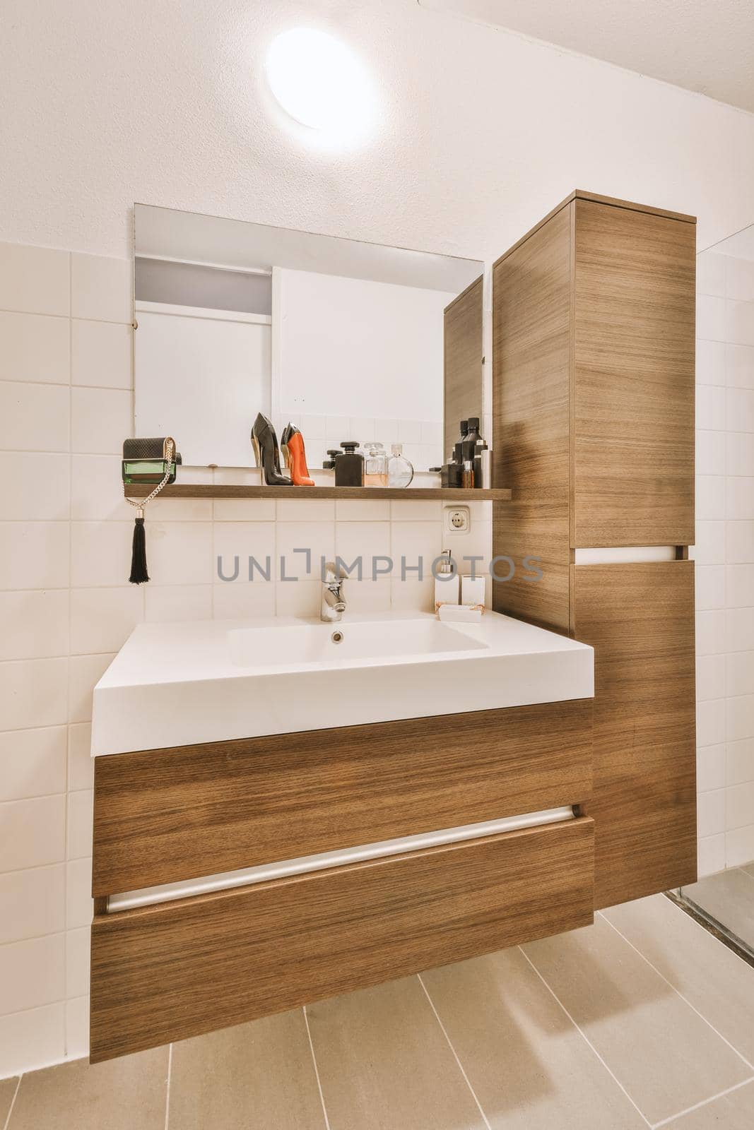 Brown cupboards and white ceramic sink by casamedia