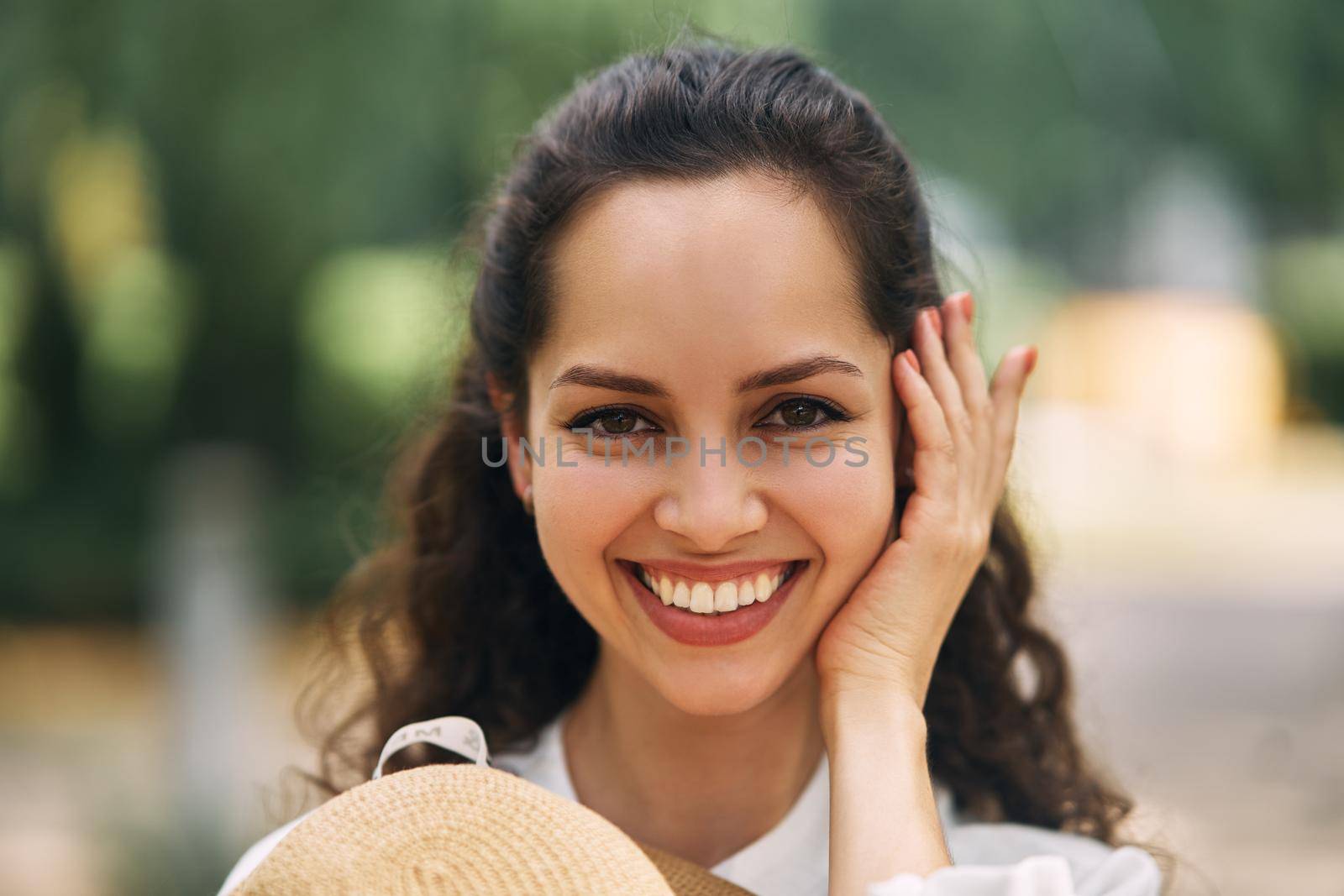 Young beautiful cheerful girl in a summer park. High quality photo