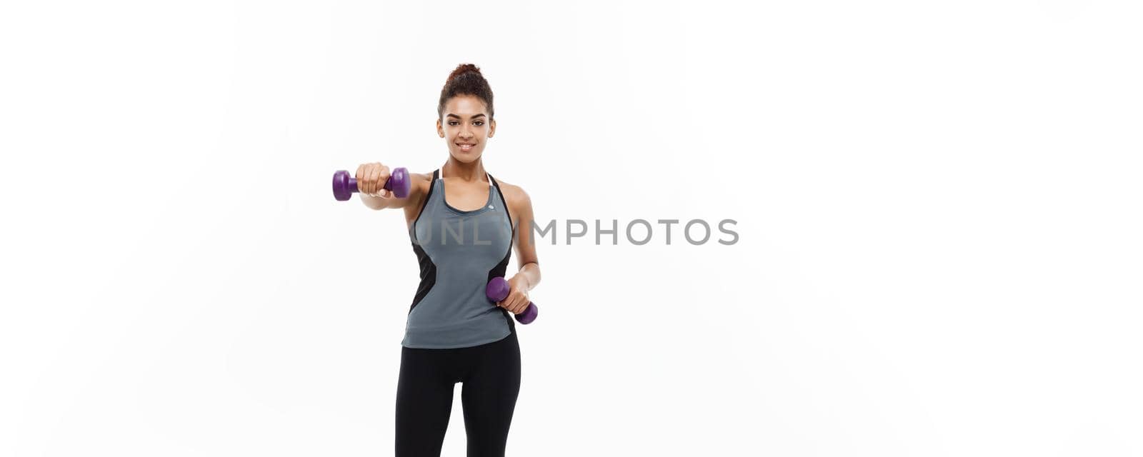 Healthy and Fitness concept - Full-length of portrait Beautiful American African lady in grey fitness clothes workout with dumbbell. Isolated on white background