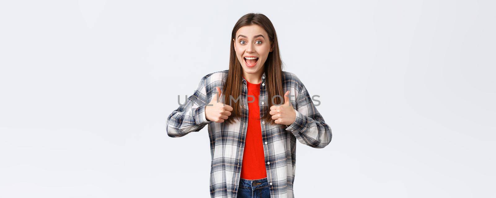 Lifestyle, different emotions, leisure activities concept. Super good idea. Cheerful excited pretty woman in casual checked shirt, thumbs-up and smiling, approving, like idea or support your choice.