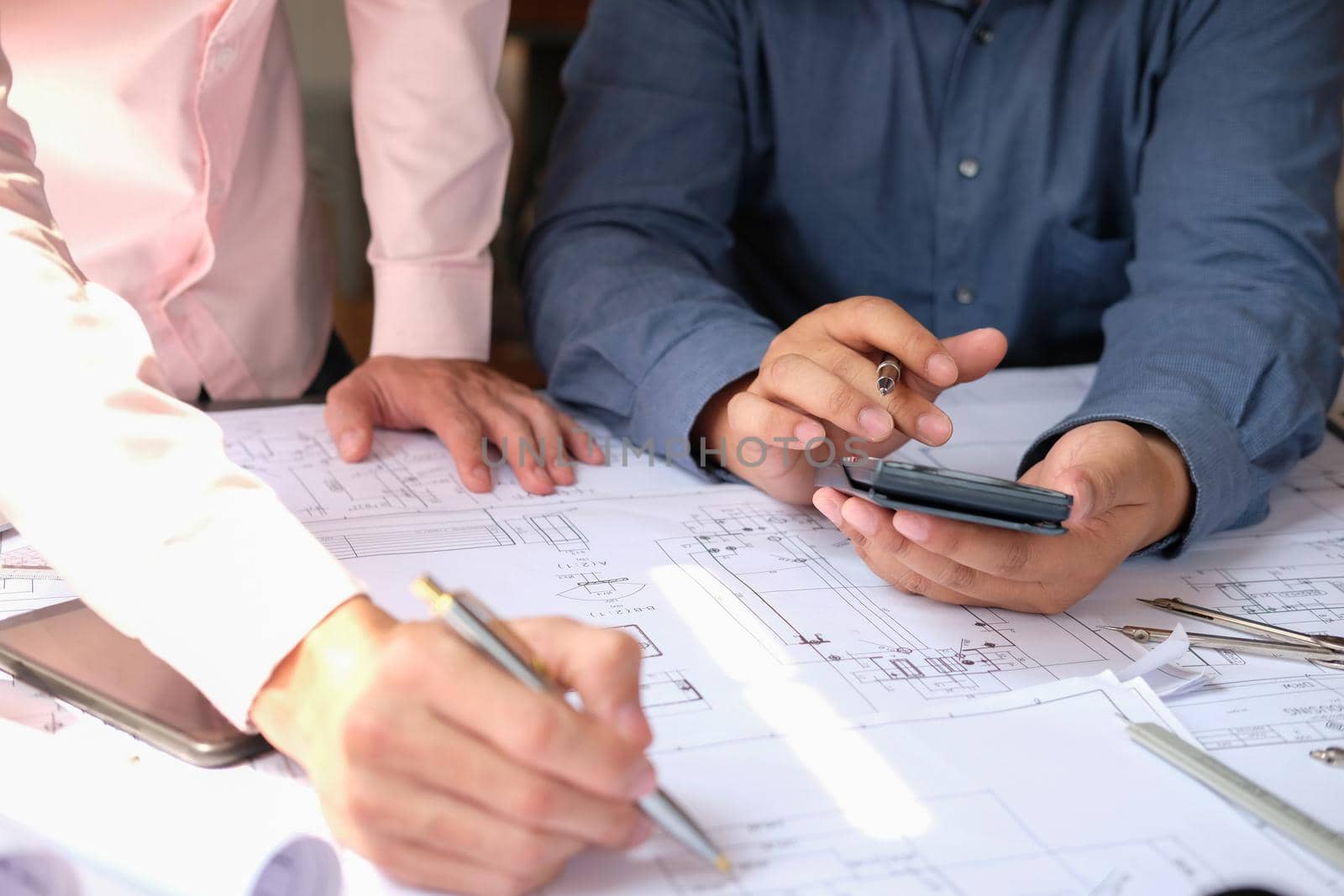 architect engineer team working on house blueprint of real estate project at workplace. building construction teamwork concept