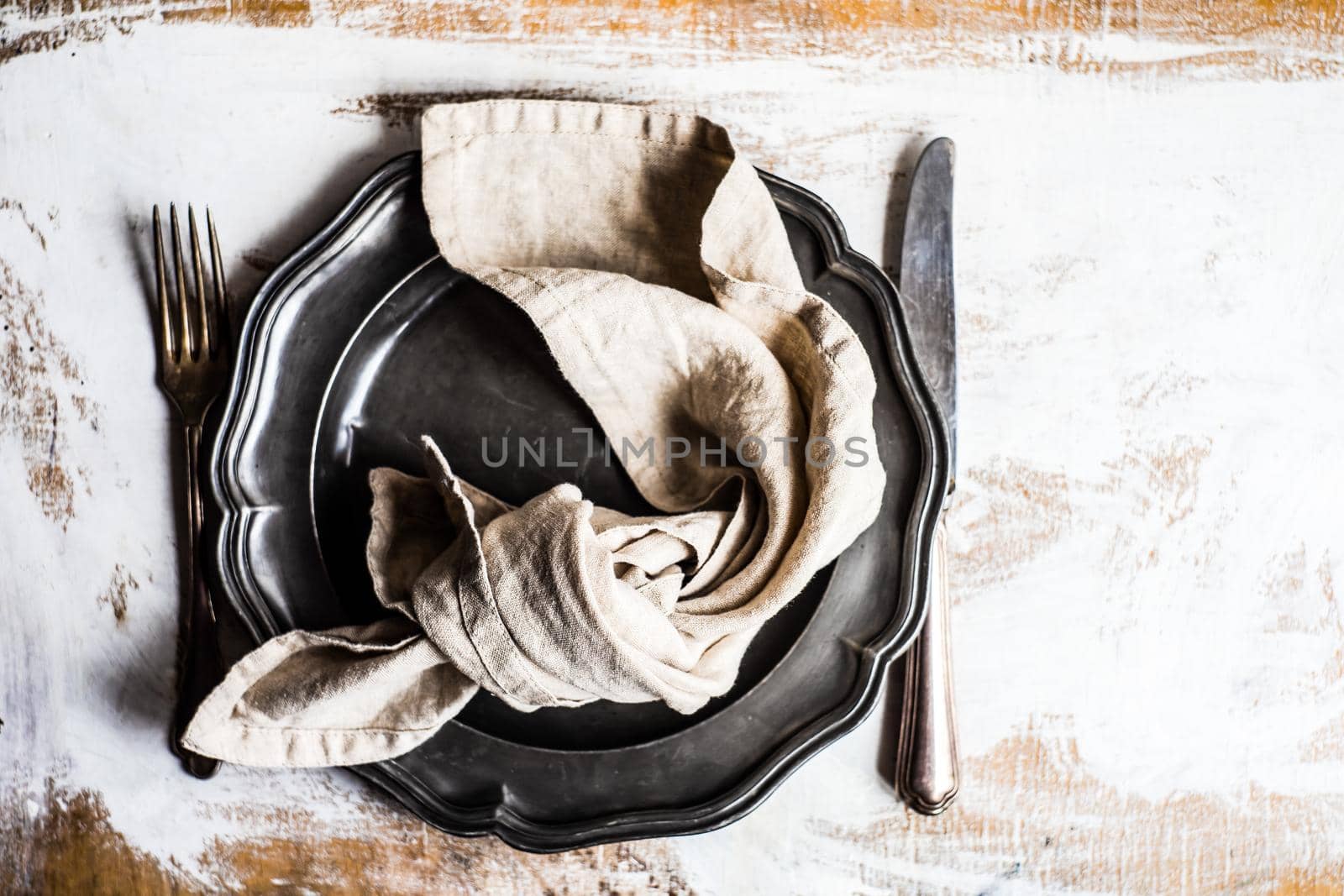 Rustic table setting with vintage cutlery on wooden table