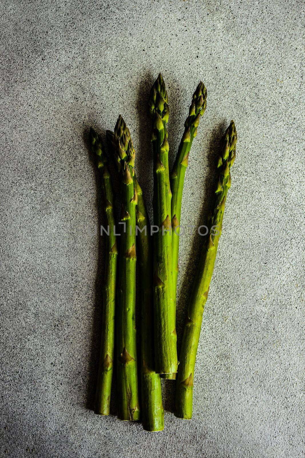 Organic food concept with asparagus on stone table with copy space